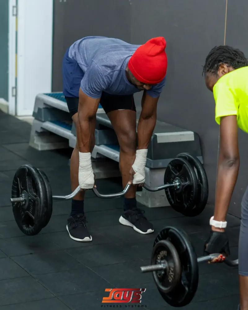 A JFS member lifting a barbell at the gym in Great Wall Mall, Pridelands